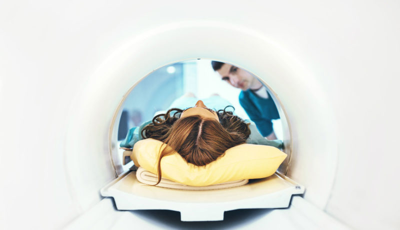 woman enters MRI with head on a pillow