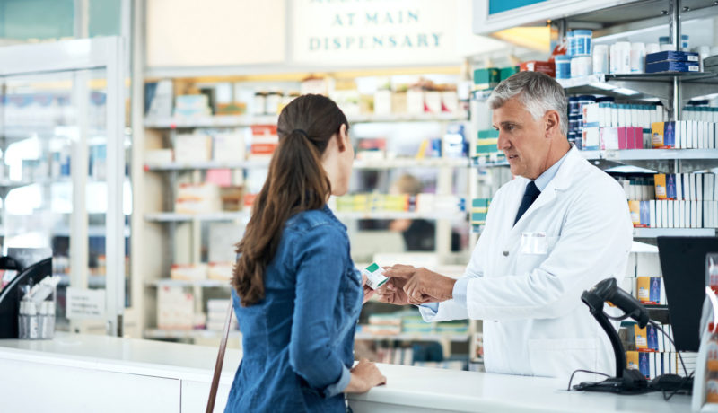 Pharmacist helps woman with her perscription