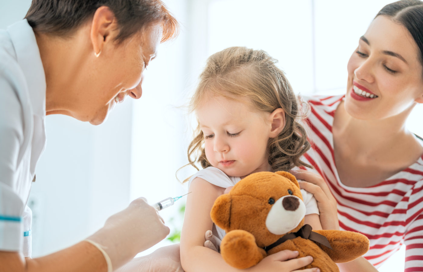 child getting vaccinated in doctor's office